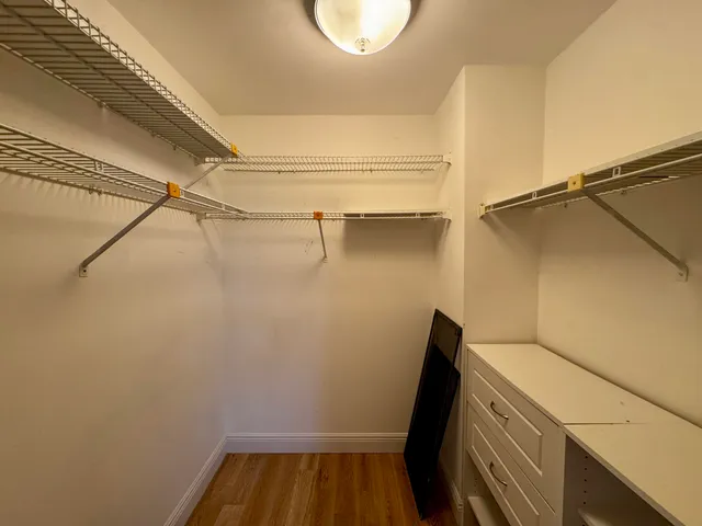 a view of a room with wooden floor