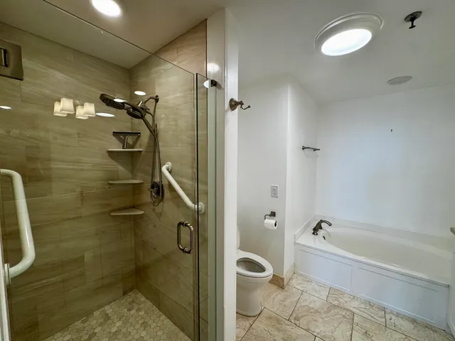 a bathroom with a bathtub and shower