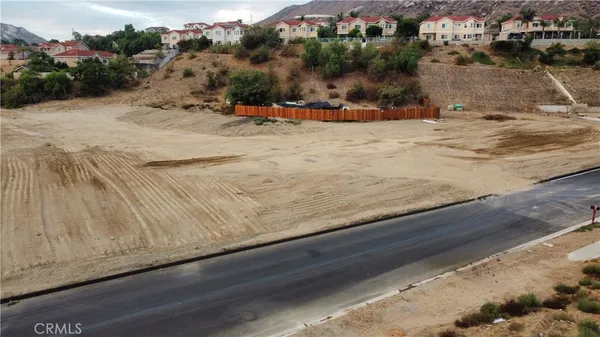 an aerial view of residential houses with city view