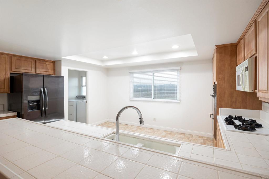 13236 Fiji Way, Unit L Marina del Rey, CA 90292 - Photo 4 of 19 a view of a kitchen with a sink and refrigerator