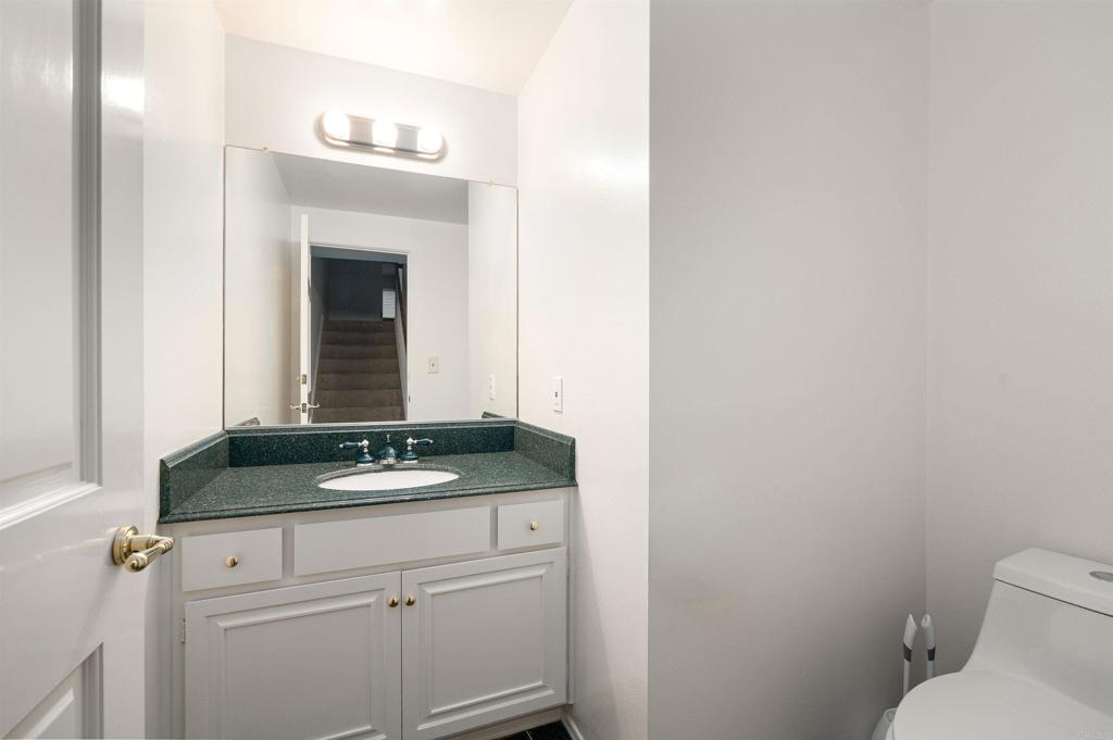 13236 Fiji Way, Unit L Marina del Rey, CA 90292 - Photo 7 of 19 a bathroom with a granite countertop sink and a toilet