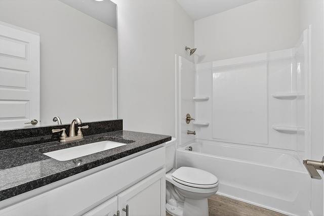 2534 Harbor Rdg Pass, Unit 344 Gainesville, GA 30507 - Photo 13 of 28 a bathroom with a granite countertop sink a toilet a mirror and shower