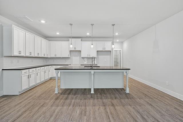 2534 Harbor Rdg Pass, Unit 344 Gainesville, GA 30507 - Photo 4 of 28 a kitchen with wooden floor and window