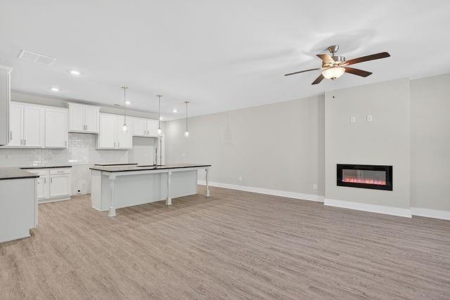 2534 Harbor Rdg Pass, Unit 344 Gainesville, GA 30507 - Photo 5 of 28 a kitchen with a refrigerator and white cabinets