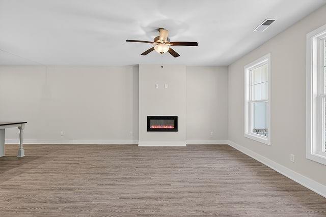 2534 Harbor Rdg Pass, Unit 344 Gainesville, GA 30507 - Photo 7 of 28 a view of an empty room with wooden floor and a window