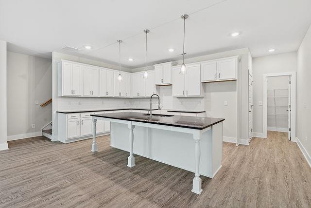 2534 Harbor Rdg Pass, Unit 344 Gainesville, GA 30507 - Photo 8 of 28 a kitchen with stainless steel appliances granite countertop a sink a stove a refrigerator and a island with wooden floor