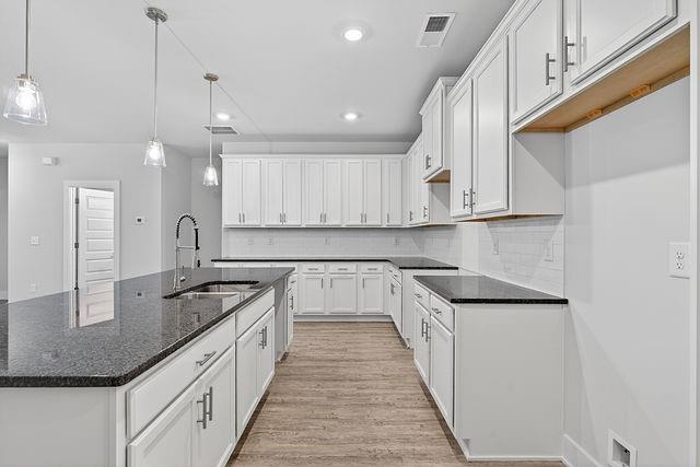 2534 Harbor Rdg Pass, Unit 344 Gainesville, GA 30507 - Photo 9 of 28 a kitchen with stainless steel appliances granite countertop a sink a stove and a refrigerator