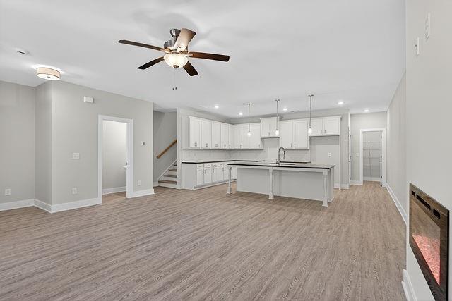 2534 Harbor Rdg Pass, Unit 344 Gainesville, GA 30507 - Photo 10 of 28 a view of an empty room and kitchen with wooden floor