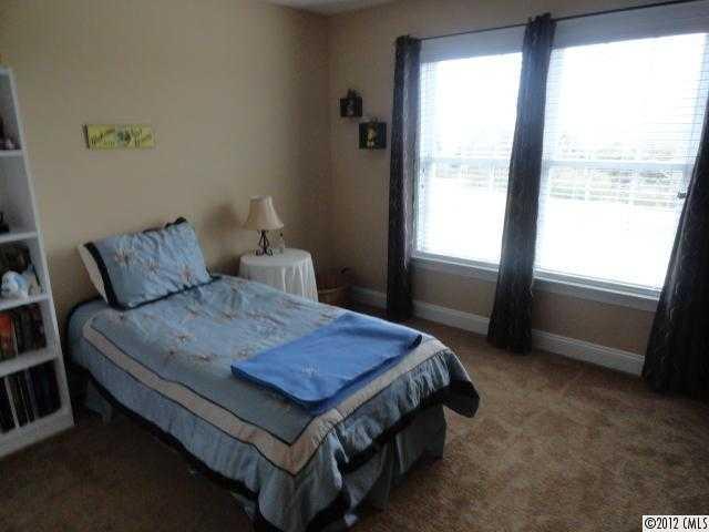 1137 Crossland Road Clover, SC 29710 - Photo 13 of 16 a bed sitting in a bedroom next to a window