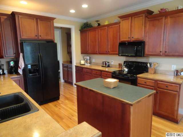 1137 Crossland Road Clover, SC 29710 - Photo 9 of 16 a kitchen with stainless steel appliances granite countertop a refrigerator a stove top oven a sink and dishwasher