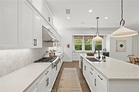 a kitchen with counter top space a sink a window and stainless steel appliances