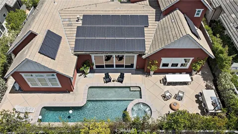 an aerial view of a house with swimming pool and porch