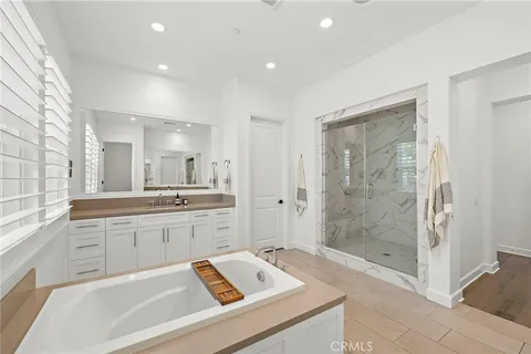 a spacious bathroom with a shower tub mirror and double