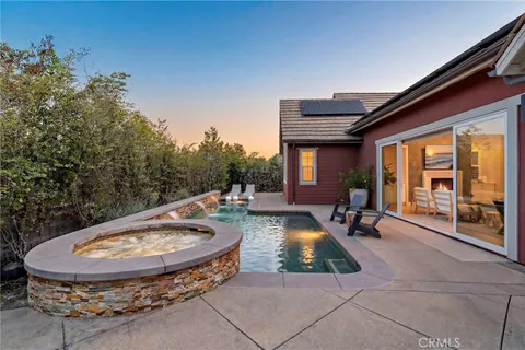 a view of a swimming pool with a lounge chairs in a patio
