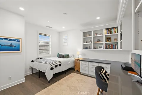 a bedroom with a bed and a chair