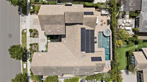 a aerial view of a house with a yard and potted plants
