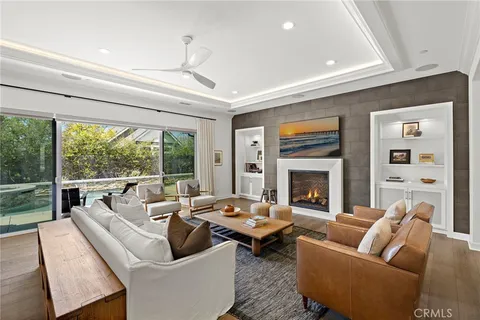 a living room with furniture fireplace and a large window