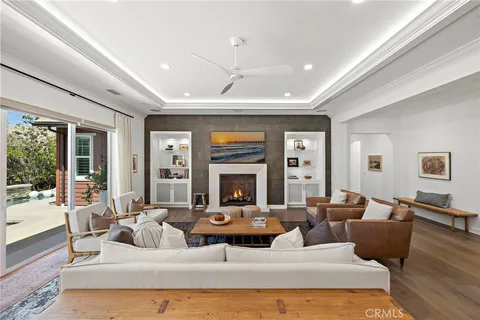 a living room with furniture large window and a fireplace