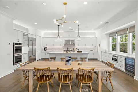 a large kitchen with a table and chairs