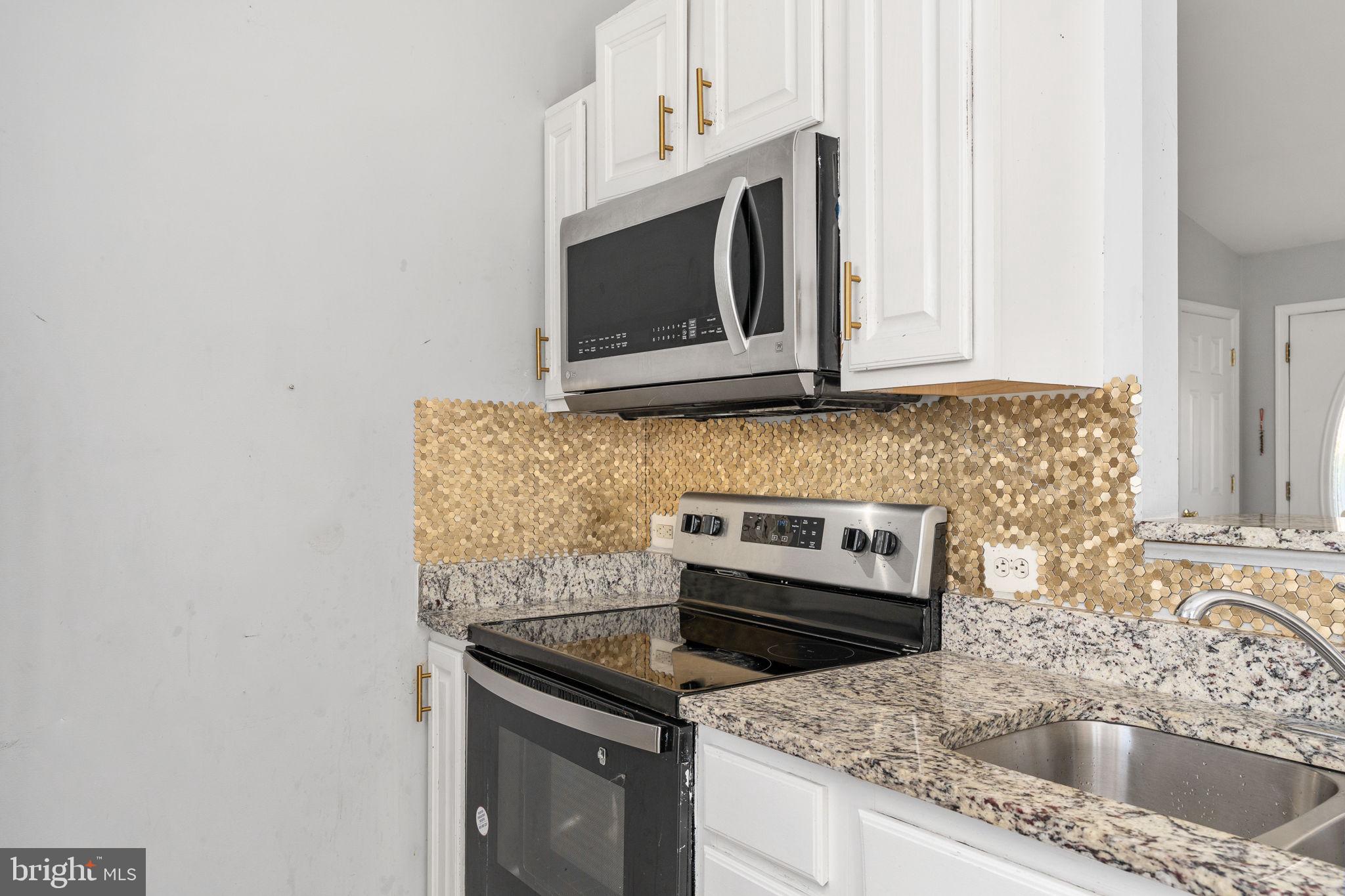 7541 Eggbornsville Road Rixeyville, VA 22737 - Photo 13 of 61 a kitchen with granite countertop a sink stove and microwave