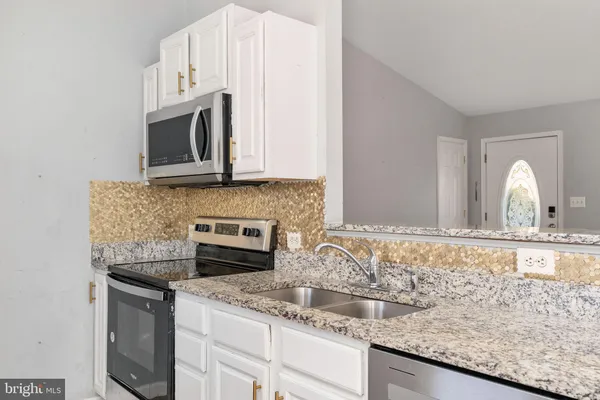 a bathroom with a sink toilet and window