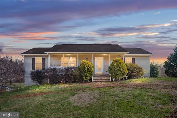 a living room with furniture a fireplace and next to a window