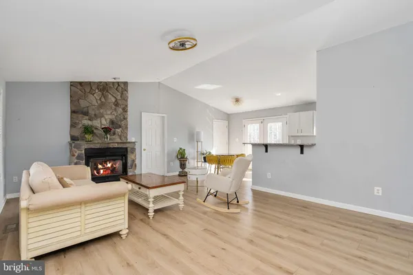 a kitchen with granite countertop a sink stove and microwave