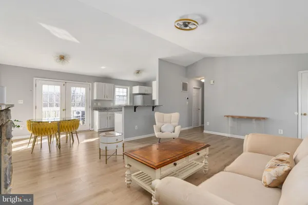 a view of a livingroom with wooden floor and window