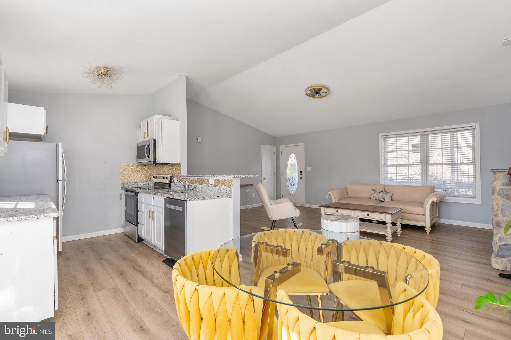 7541 Eggbornsville Road Rixeyville, VA 22737 - Photo 10 of 61 a living room with a couch and a dining table with wooden floor
