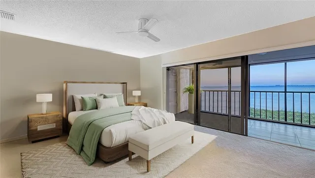 a bedroom with a bed and a large window