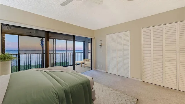 a bedroom with a large bed and a large window