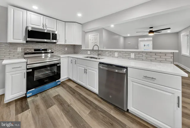 a kitchen with a sink stove and microwave