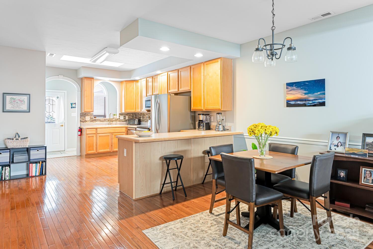121 Shadowbrook Drive Asheville, NC 28805 - Photo 11 of 32 a view of a dining room with furniture window and wooden floor