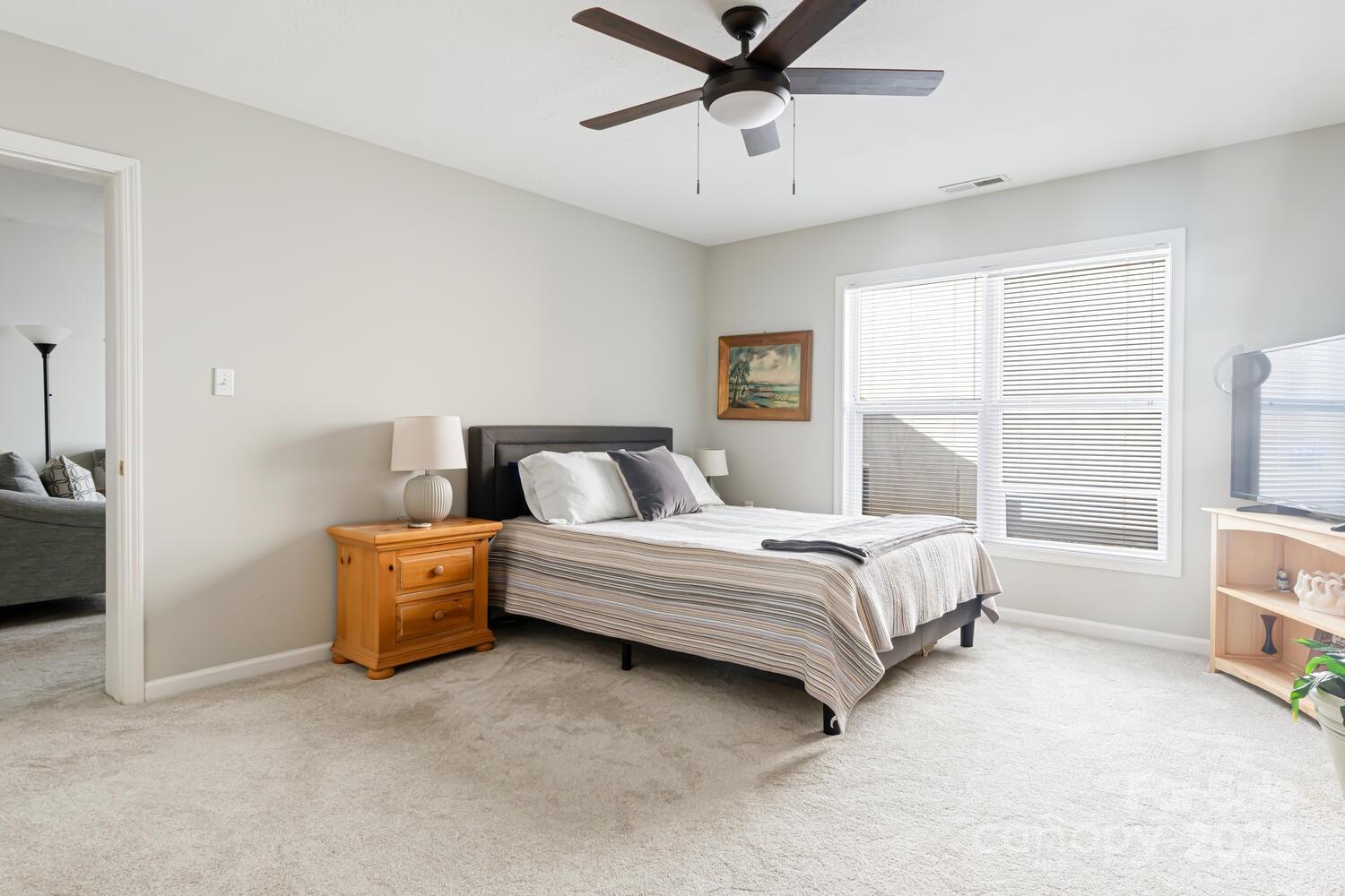 121 Shadowbrook Drive Asheville, NC 28805 - Photo 22 of 32 a spacious bedroom with a bed and a window