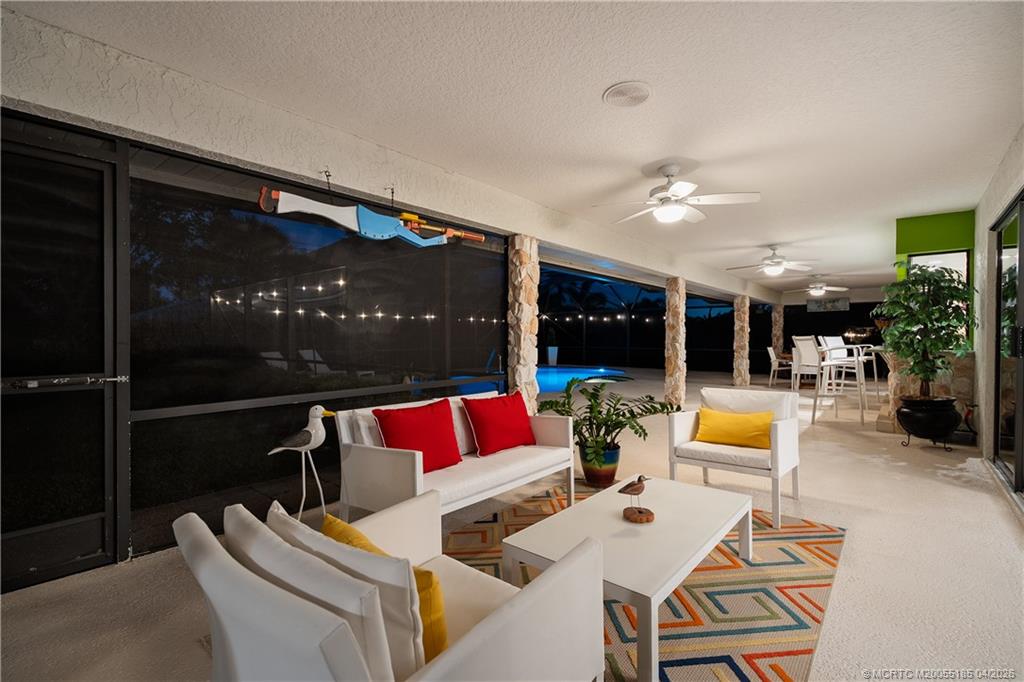 4620 Southeast Quail Trail Stuart, FL 34997 - Photo 54 of 71 a outdoor space with patio the couches and pool dining table with chairs