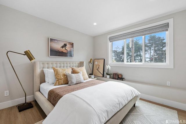 a bedroom with bed and painting on the wall