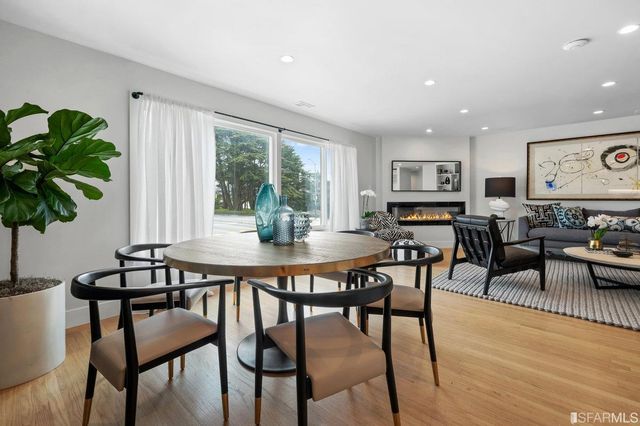 a view of a dining room with furniture window and wooden floor