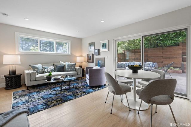 a kitchen with refrigerator a sink and chairs