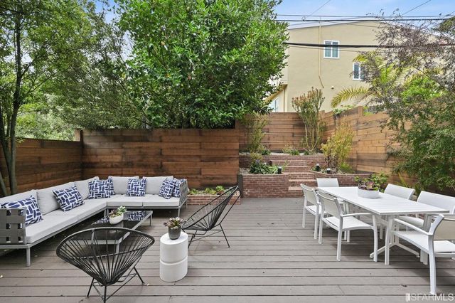 a view of a patio with table and chairs and couches