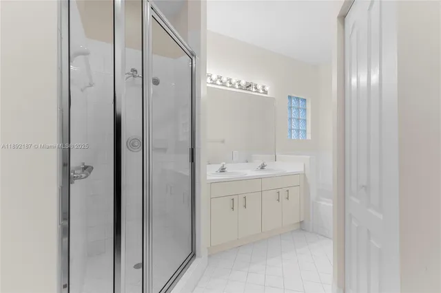 a bathroom with a double vanity sink and mirror