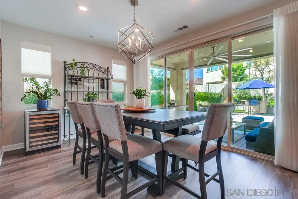 1933 Pascal Court Escondido, CA 92026 - Photo 13 of 52 a view of a dining room with furniture wooden floor and chandelier