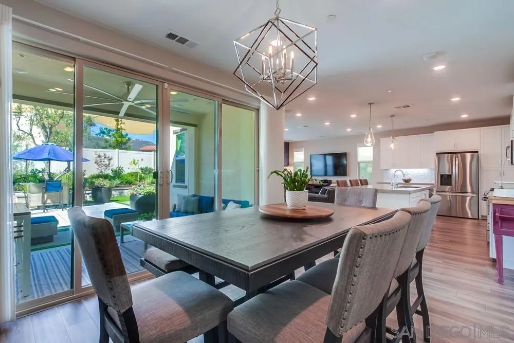1933 Pascal Court Escondido, CA 92026 - Photo 14 of 52 a view of a dining room with furniture a chandelier and wooden floor