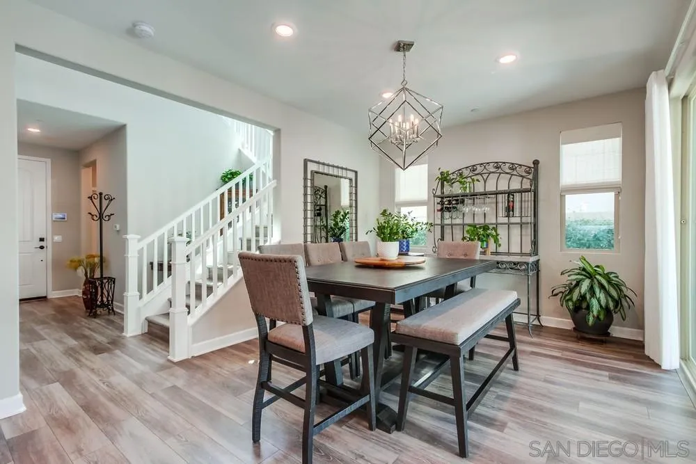 1933 Pascal Court Escondido, CA 92026 - Photo 16 of 52 a view of a dining room with furniture wooden floor and chandelier