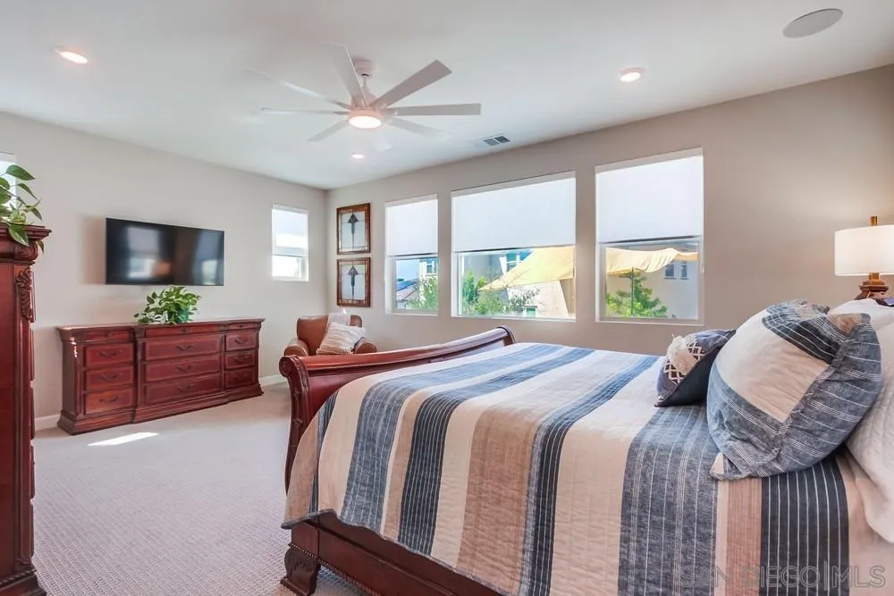 1933 Pascal Court Escondido, CA 92026 - Photo 25 of 52 a bedroom with a bed and windows