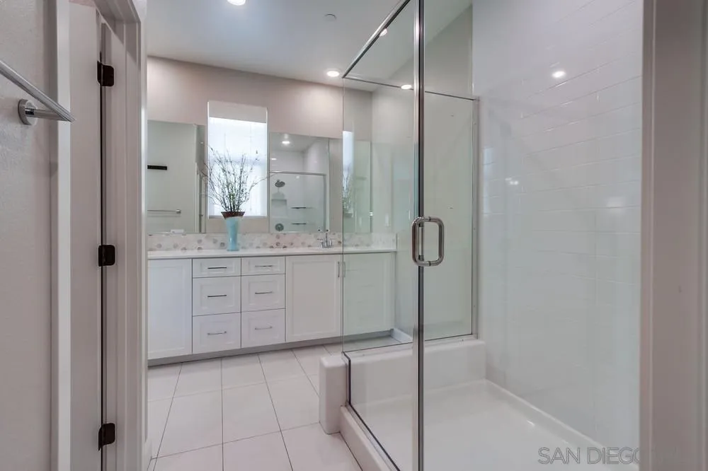 1933 Pascal Court Escondido, CA 92026 - Photo 28 of 52 a bathroom with a granite countertop sink mirror and shower