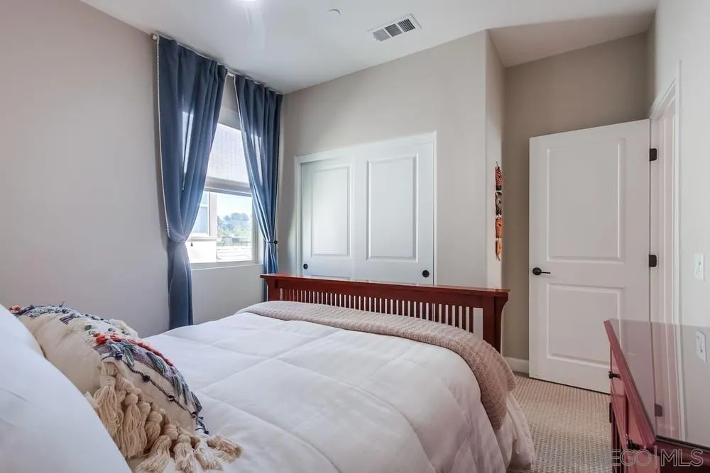 1933 Pascal Court Escondido, CA 92026 - Photo 32 of 52 a bedroom with a large bed and a window