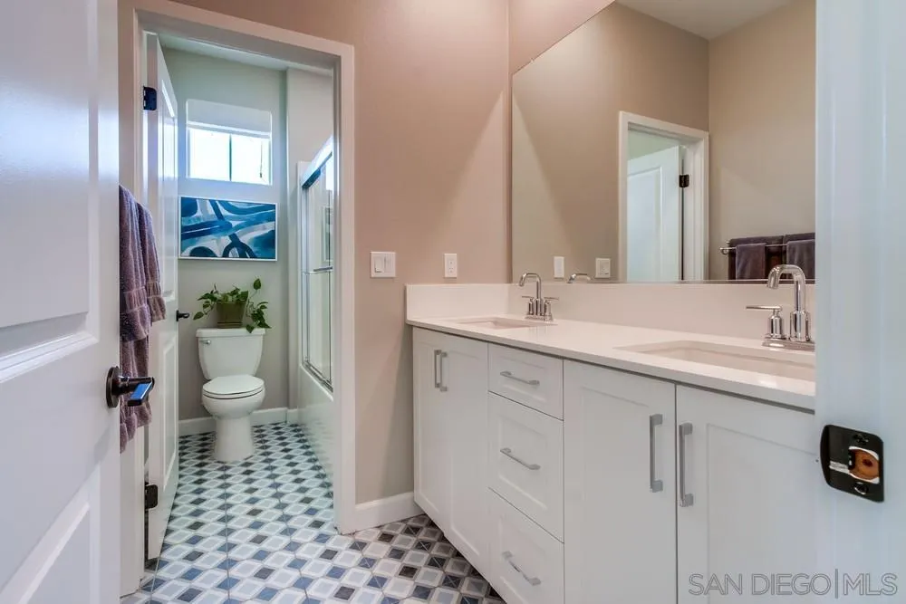 1933 Pascal Court Escondido, CA 92026 - Photo 36 of 52 a bathroom with a sink a toilet and a mirror