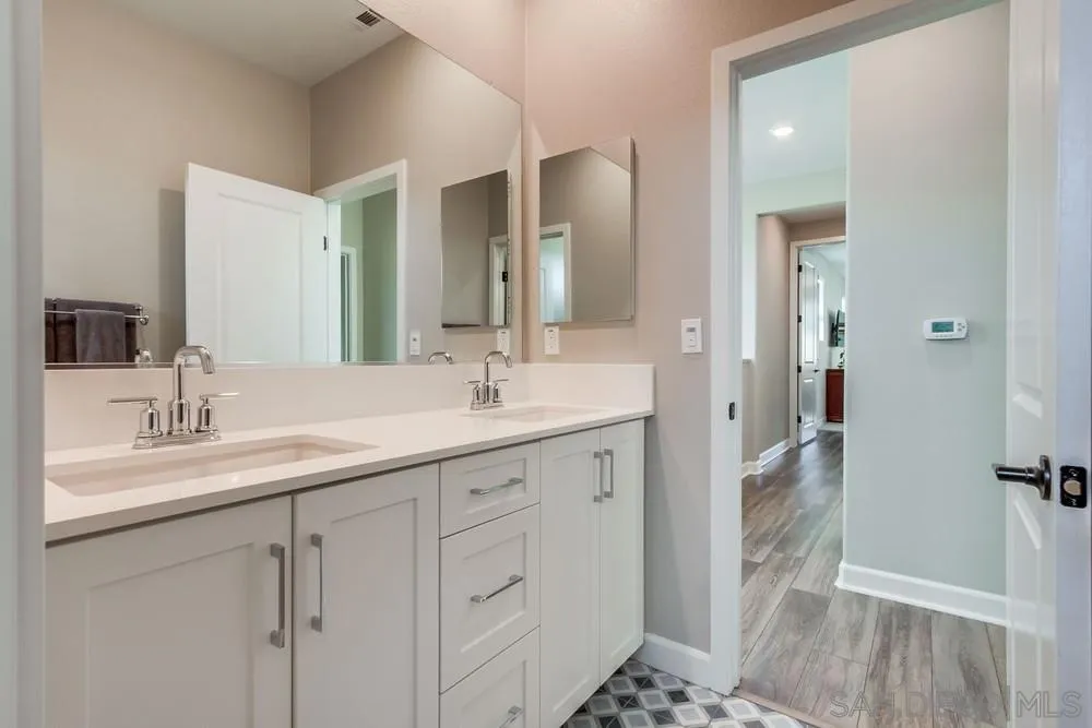 1933 Pascal Court Escondido, CA 92026 - Photo 37 of 52 a en suite bathroom with a sink a toilet and a large mirror