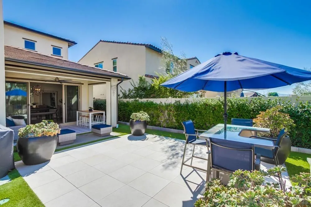 1933 Pascal Court Escondido, CA 92026 - Photo 46 of 52 a view of a patio with table and chairs under an umbrella with a barbeque grill and potted plants