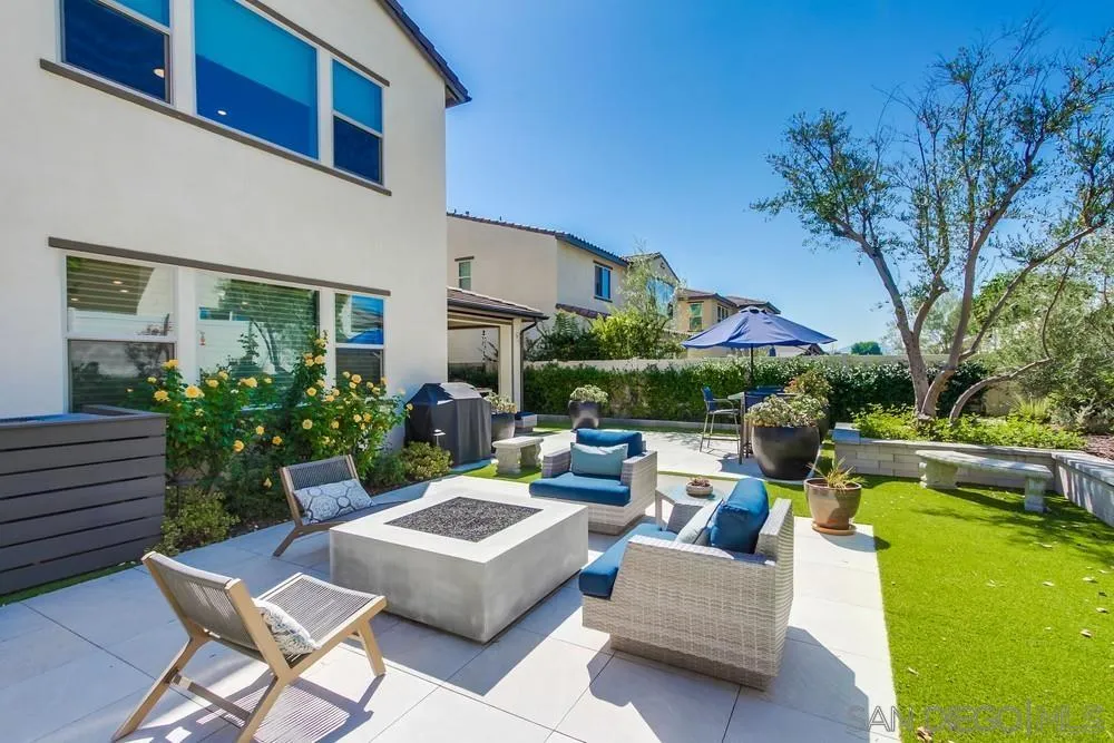 1933 Pascal Court Escondido, CA 92026 - Photo 49 of 52 a view of a patio with couches table and chairs with potted plants and big yard